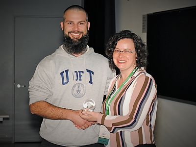 photo of Evan Sepa, Town of Orangeville, receiving the URISA award